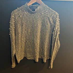 Gray long sleeve sweater with pearl detail on shoulders